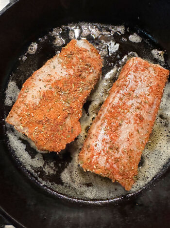 adding rubbed cod to hot skillet