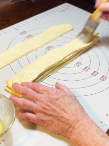 brushing strips with butter