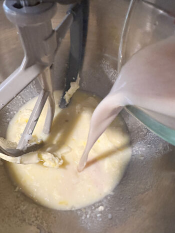adding yeast mixture to mixing bowl