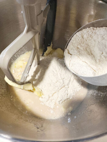 adding flour to mixing bowl