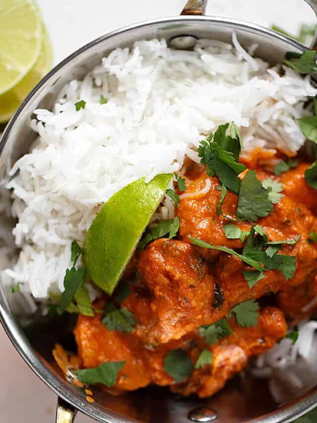 Shrimp tikka masala with rice in copper bowl