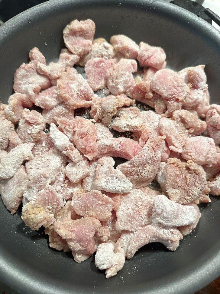 adding pork to skillet