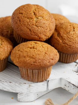 pumpkin muffins on white serving board