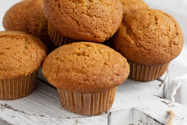 pumpkin muffins on white serving board