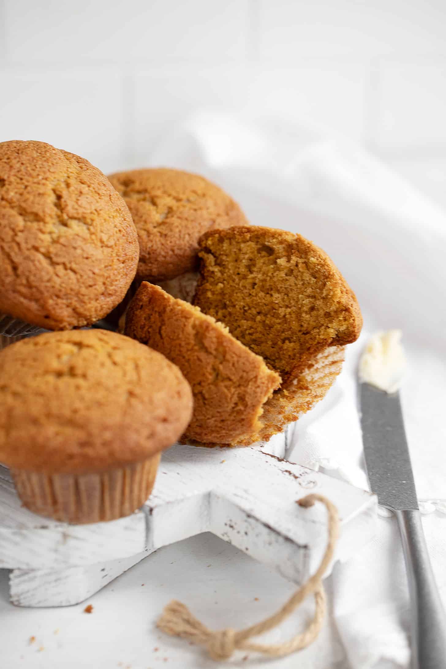 pumpkin muffins on serving tray with one cut open