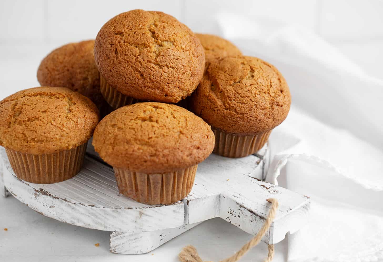 pumpkin muffins on white serving board