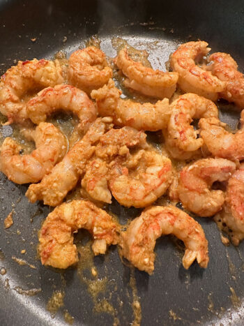 shrimp being cooked in skillet