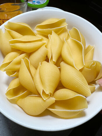 uncooked jumbo pasta shells in bowl