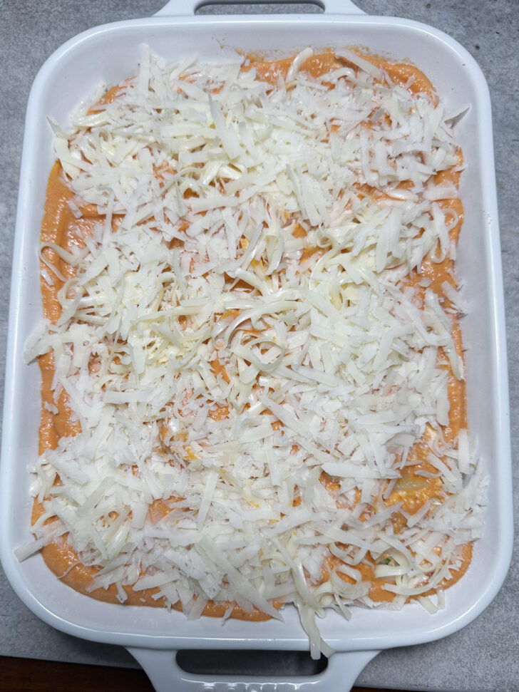 topping the casserole with remaining cheese before baking
