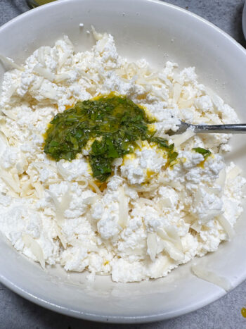 the egg yolk and basil added to the ricotta mixture
