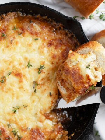 warm brie dip in cast iron skillet with bread