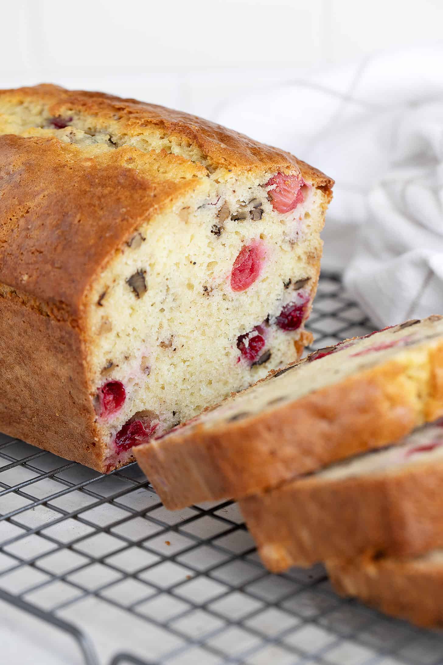 cranberry walnut bread sliced on wire rack