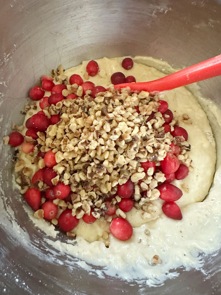 adding the walnuts and fresh cranberries to the batter