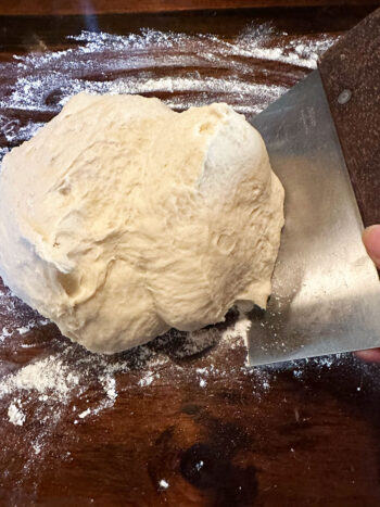 dough on floured work surface with bench scraper