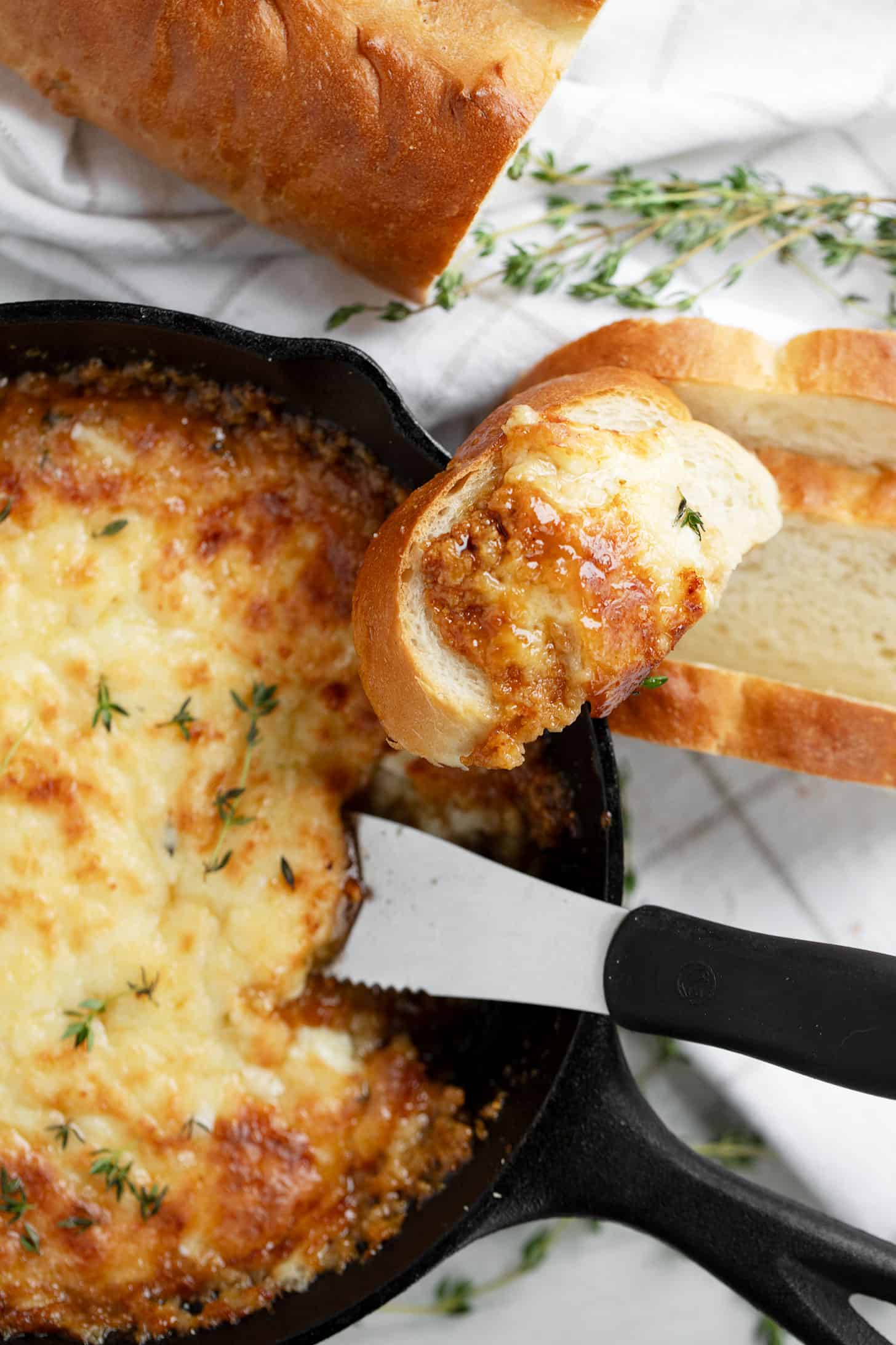 warm brie dip in baking dish with bread slices