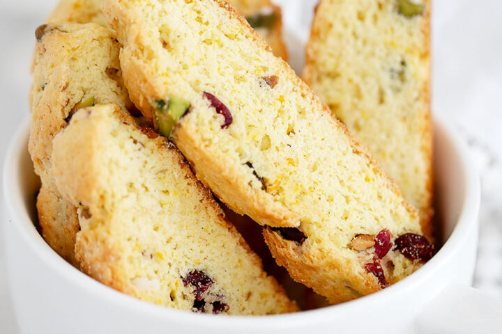 cranberry orange biscotti in large coffee cup