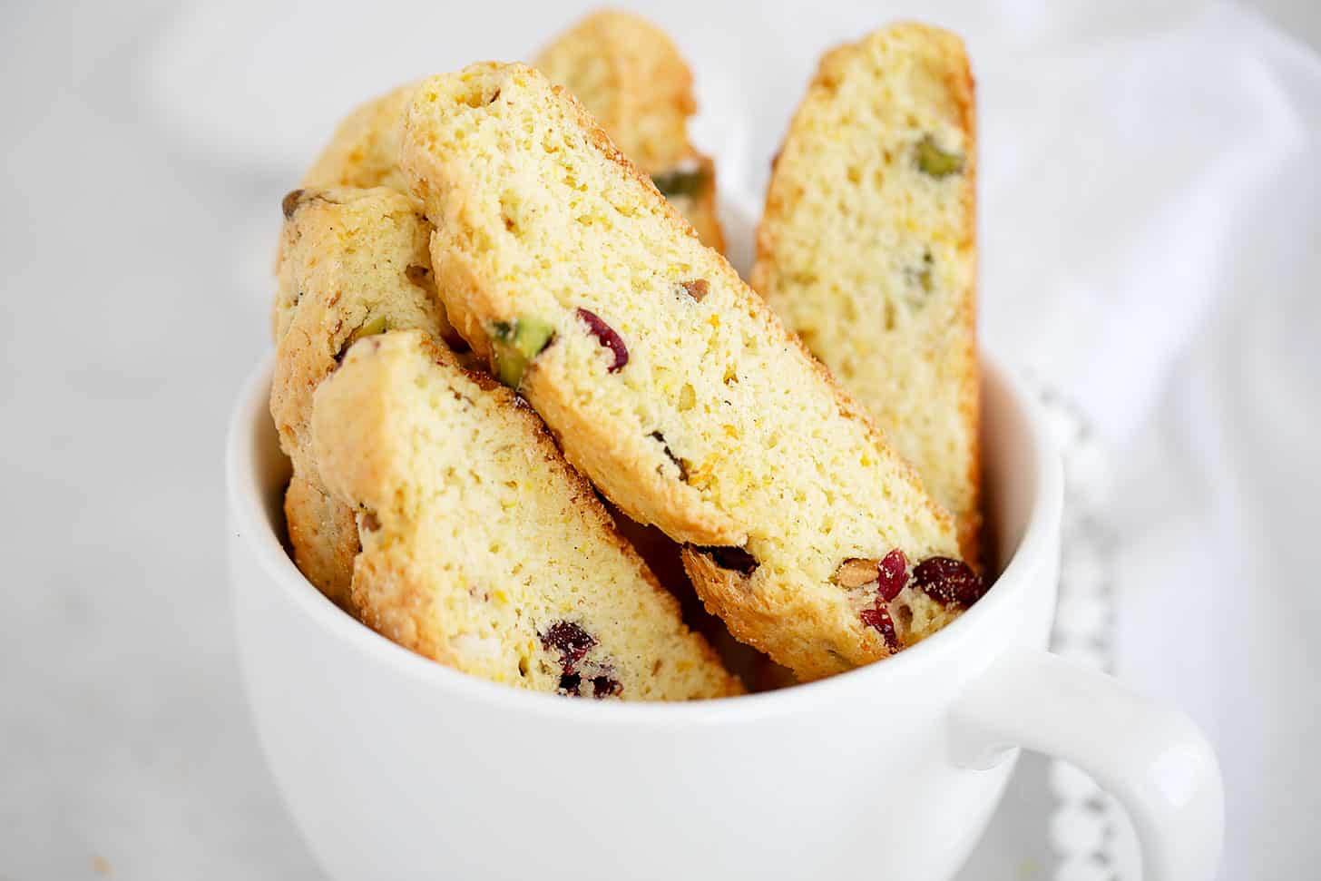 cranberry orange biscotti in large coffee cup