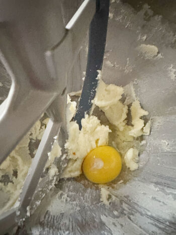 adding egg to beaten butter and sugar