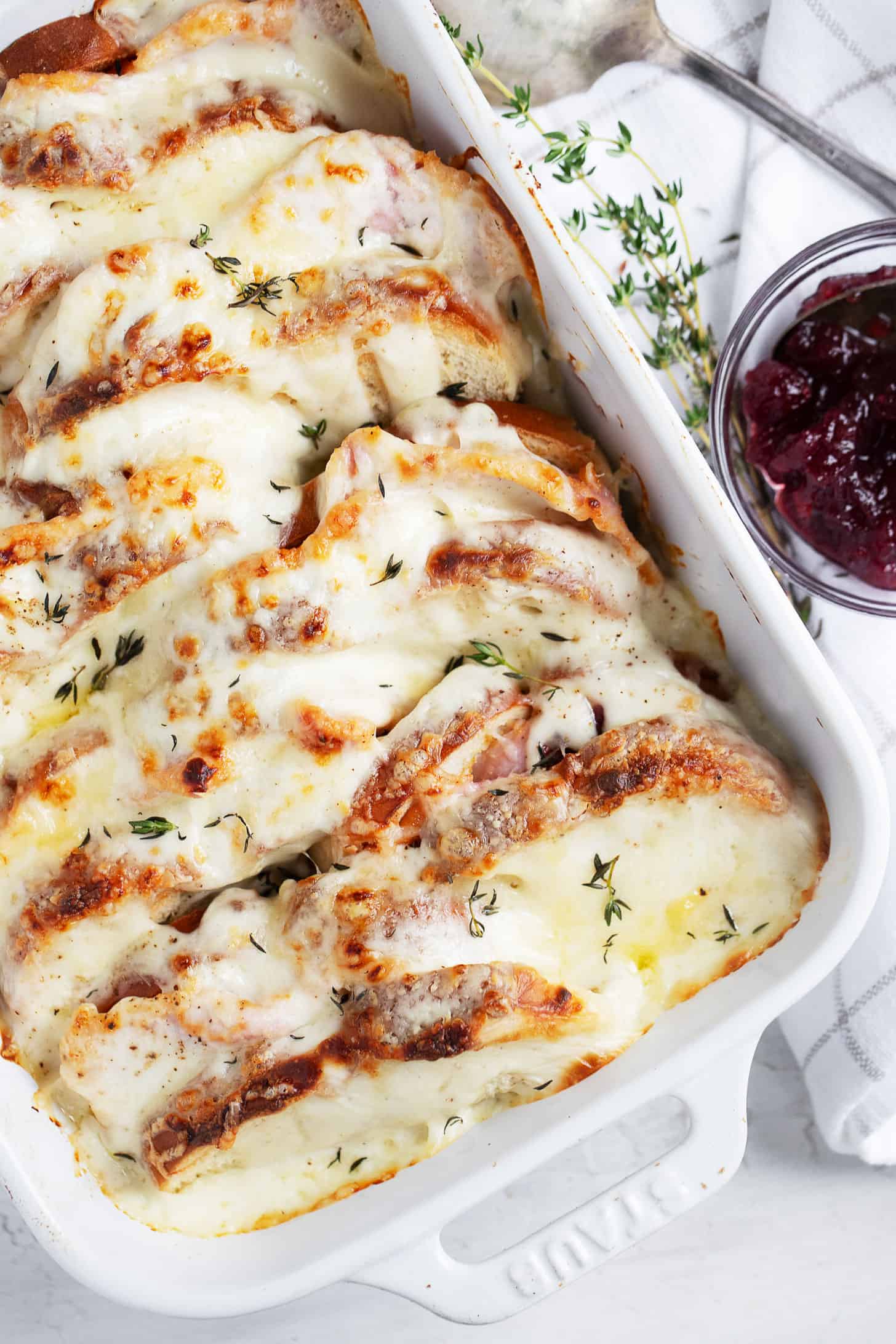 Croque Monsieur casserole in baking dish with cranberry sauce on the side