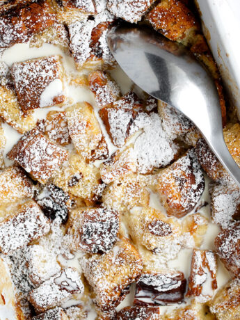 eggnog bread pudding in baking dish with spoon