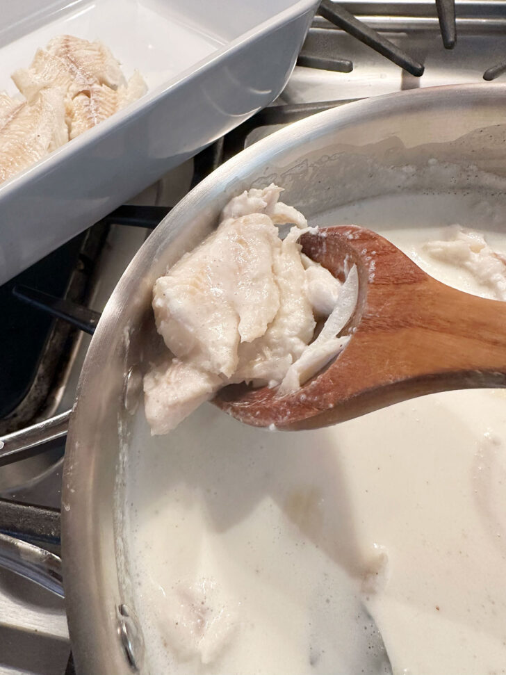 removing poached fish from milk mixture