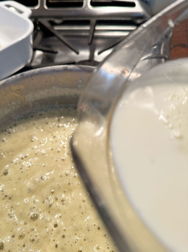 adding milk to butter and flour mixture