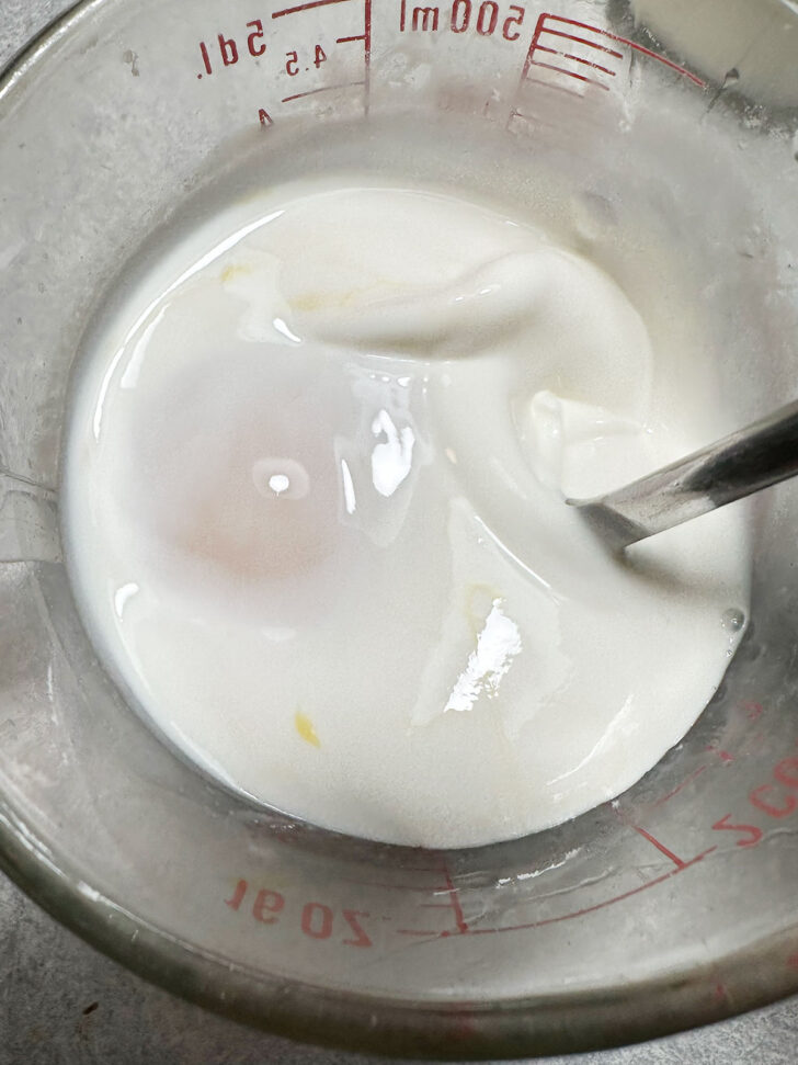 mixing eggs and cream in measuring cup