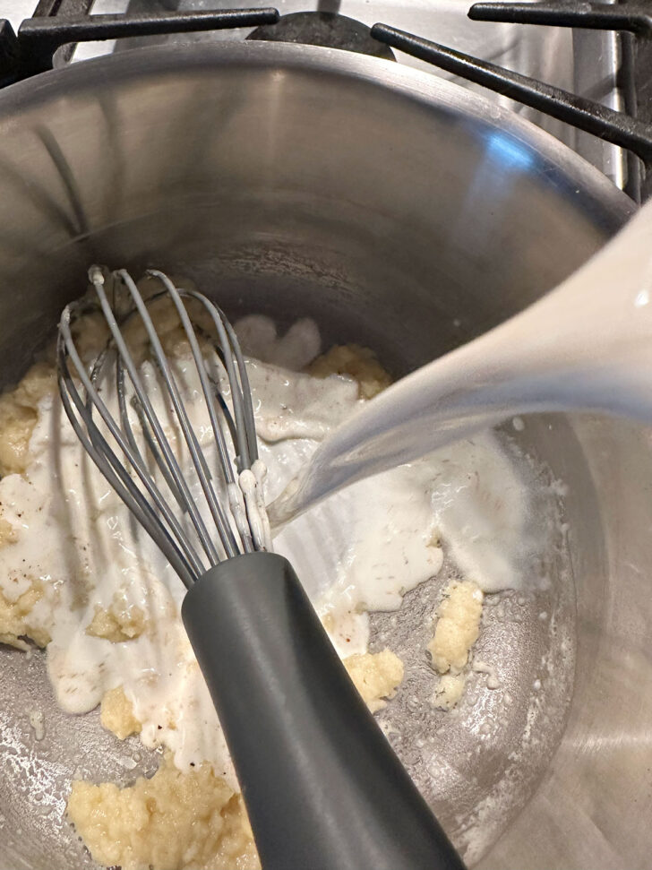 adding milk to butter and flour mixture