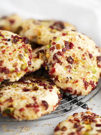 pistachio and cranberry crusted shortbread cookies on rack