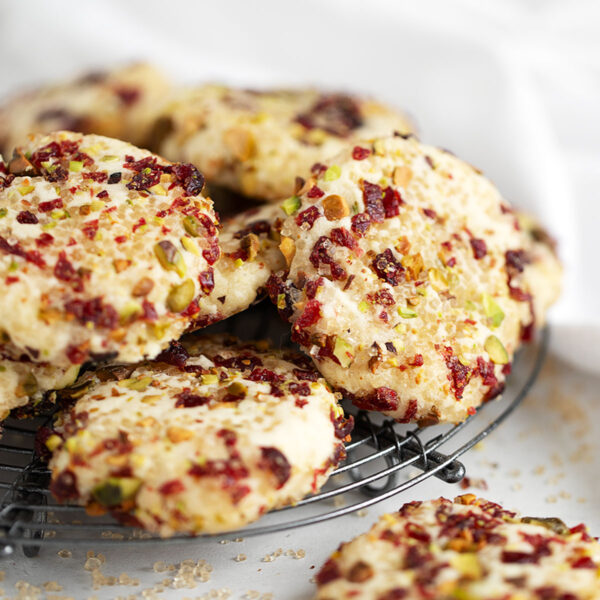 pistachio and cranberry crusted shortbread cookies on rack