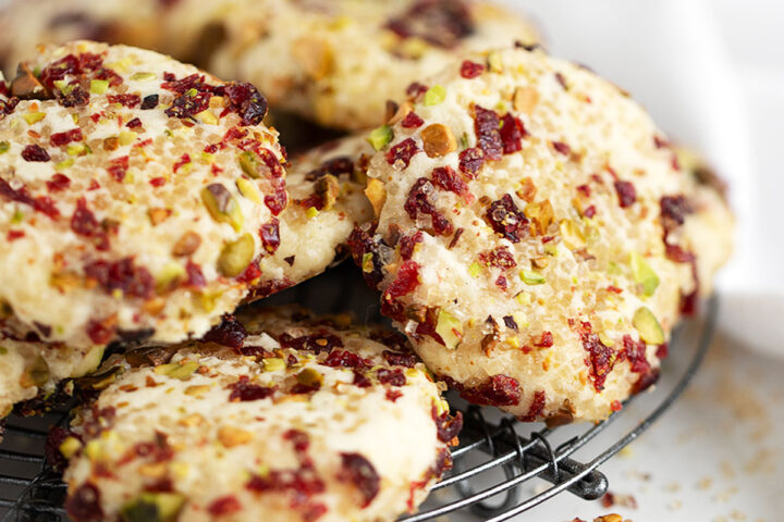 pistachio and cranberry crusted shortbread cookies on rack