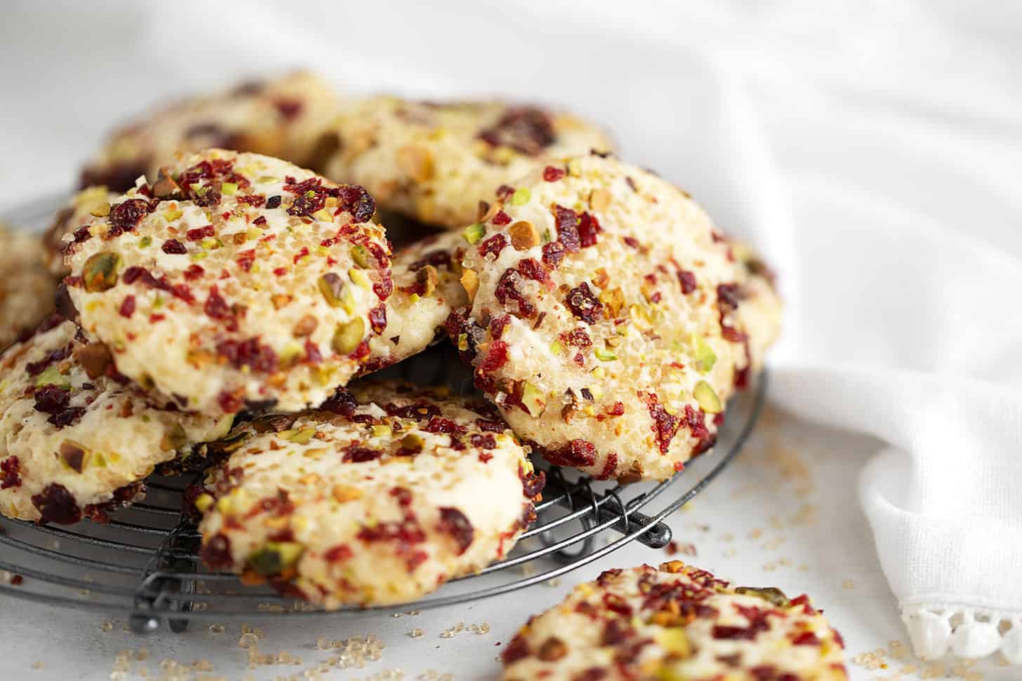 pistachio and cranberry crusted shortbread cookies on rack