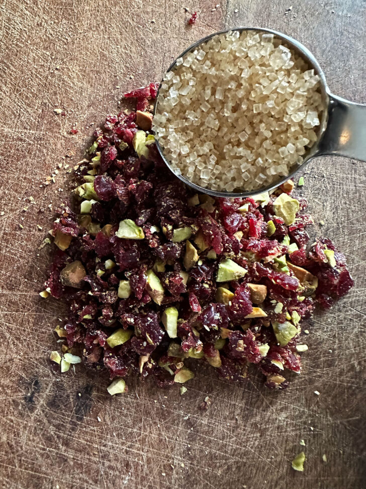 dried cranberries and pistachios after chopping and adding turbinado sugar