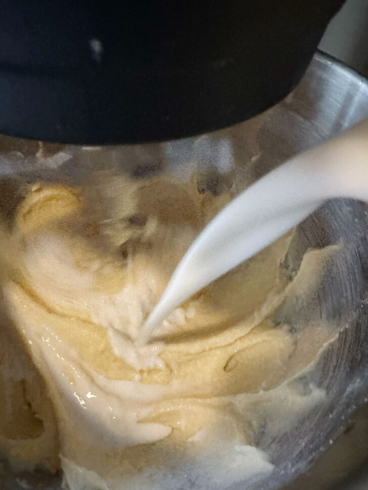 Adding the buttermilk to the cake batter.