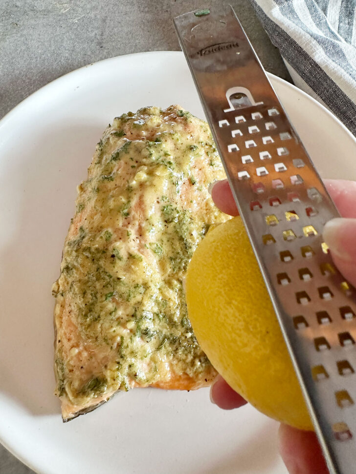 Lemon and grater for topping salmon with lemon zest.