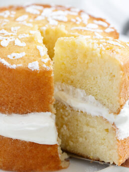 lemon syrup cake sliced on plate