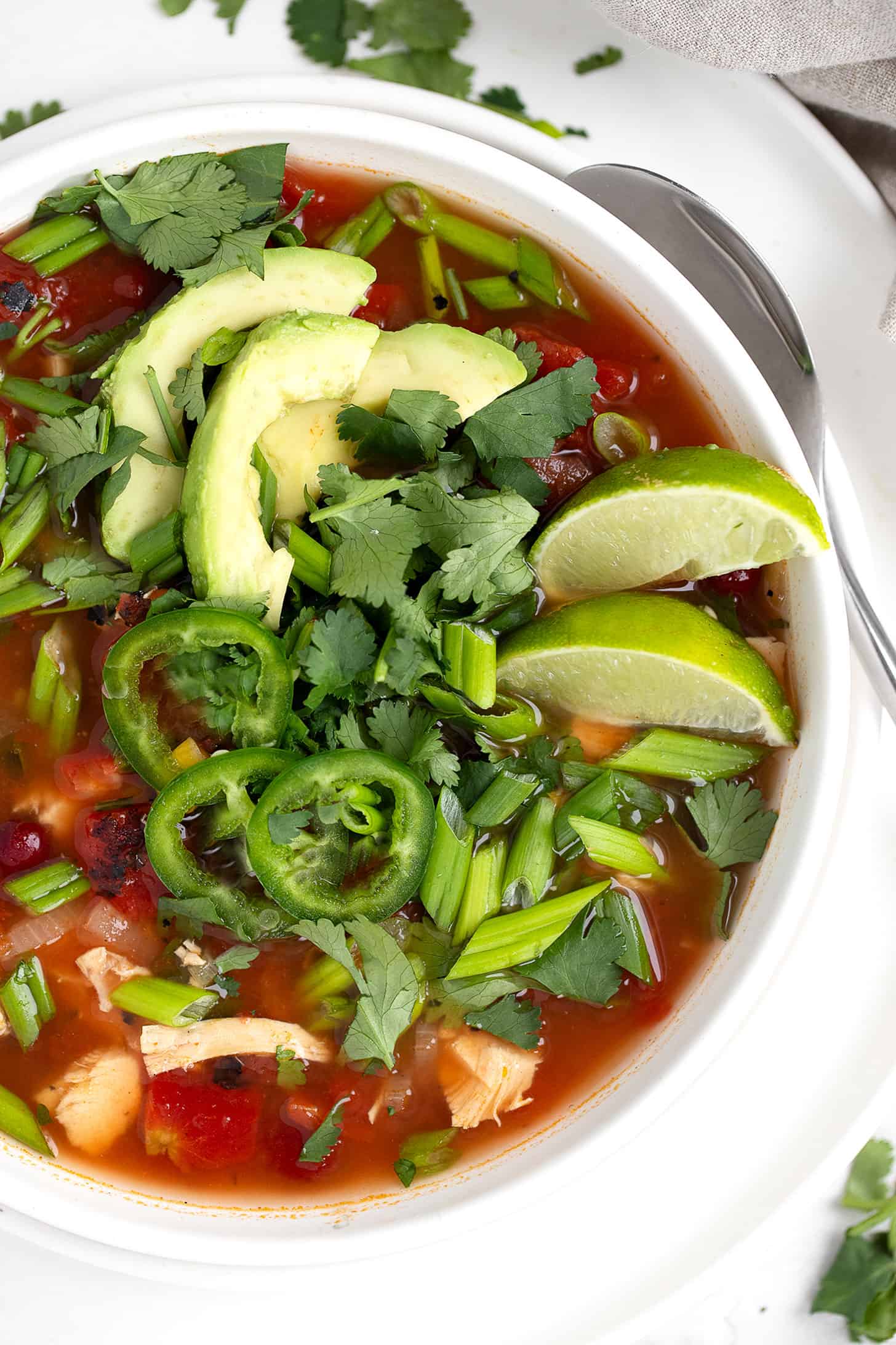 Mexican chicken soup in bowl with garnishes