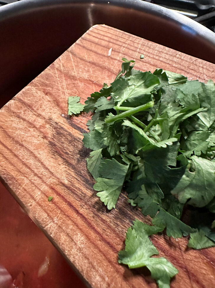adding cilantro to the pot