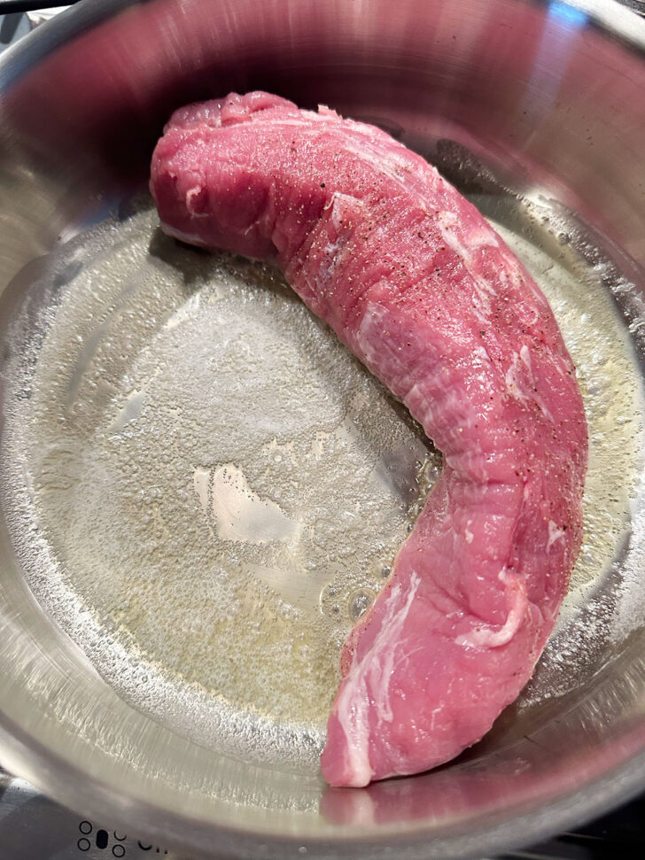 pork tenderloin added to hot skillet