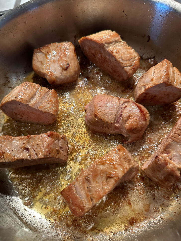 pork tenderloin slices returned to hot skillet to brown again
