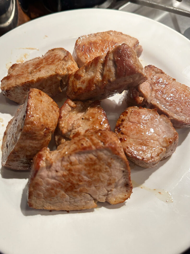 browned pork tenderloin slices removed to plate