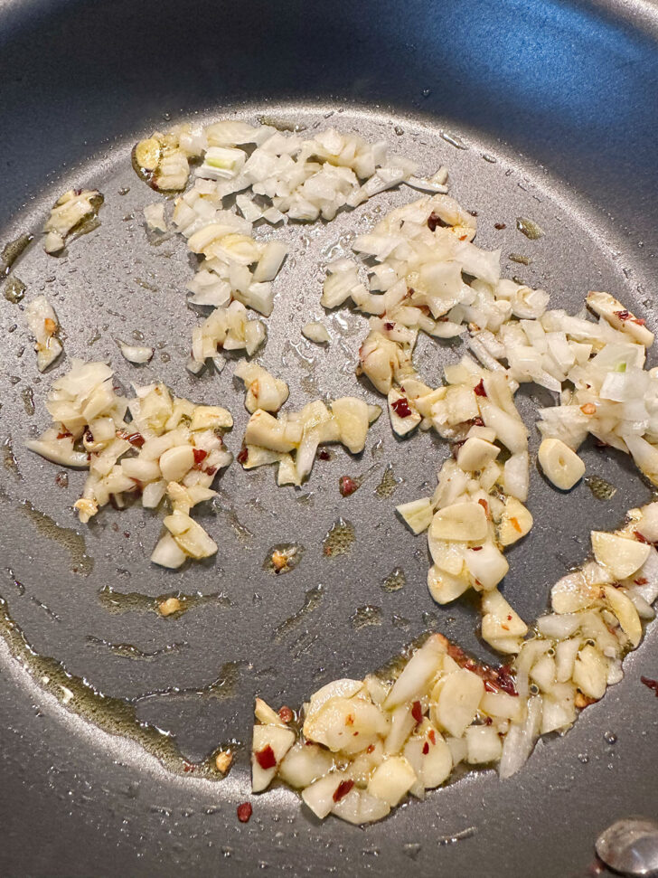 Softening onion and garlic in skillet.