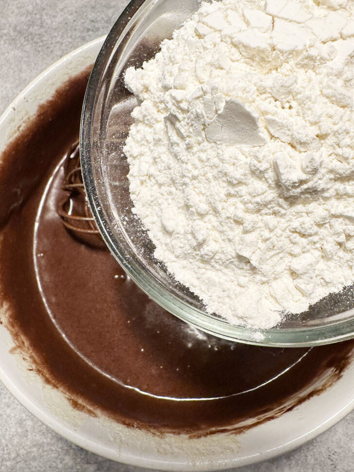 Adding flour to chocolate mixture.