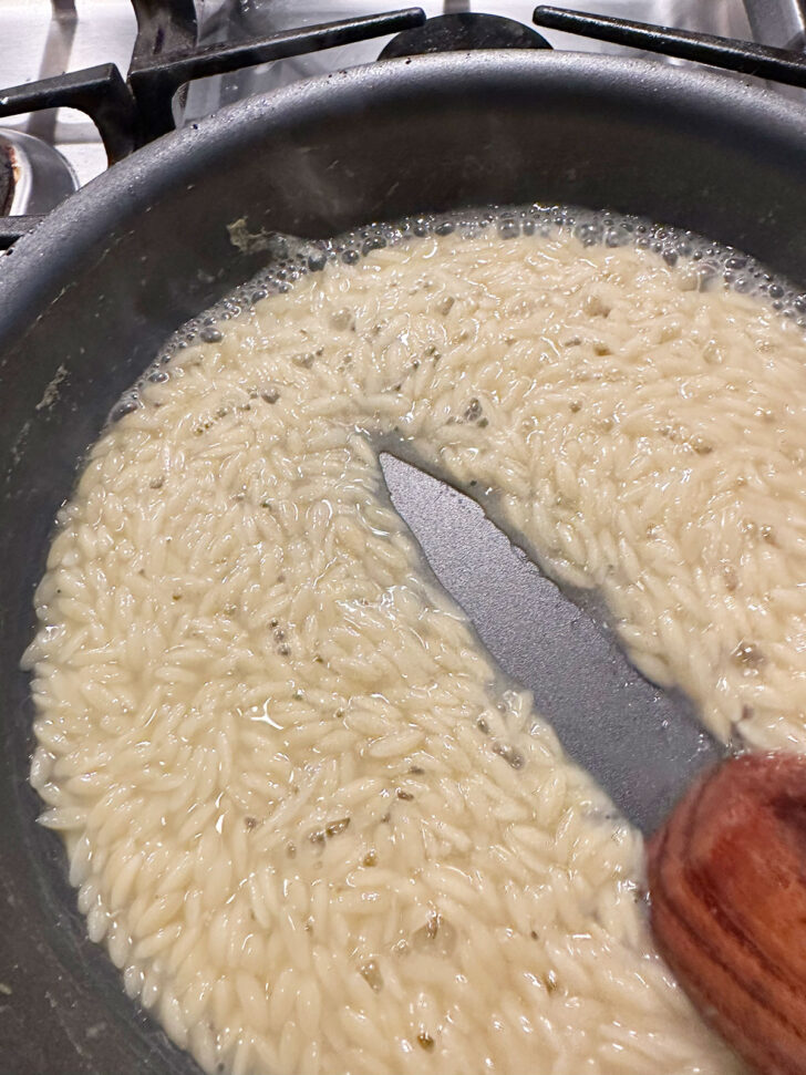 Orzo cooked with just a bit of liquid in the pan.