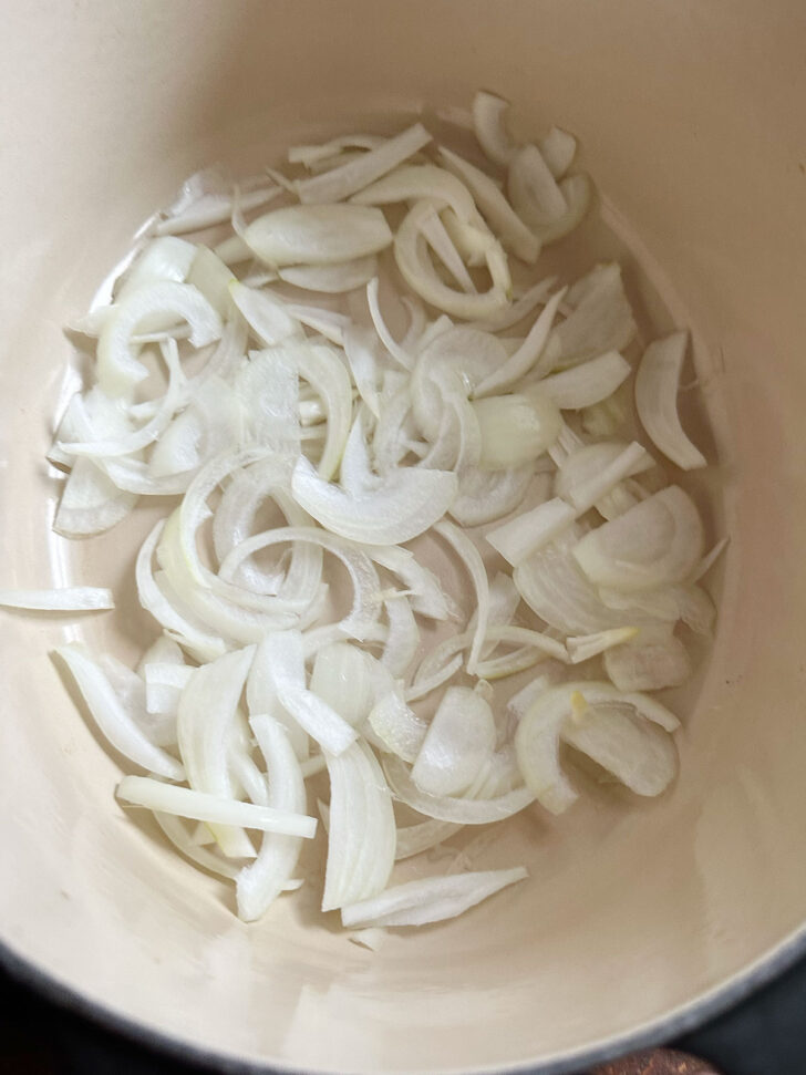 Onions in the bottom of the baking dish.