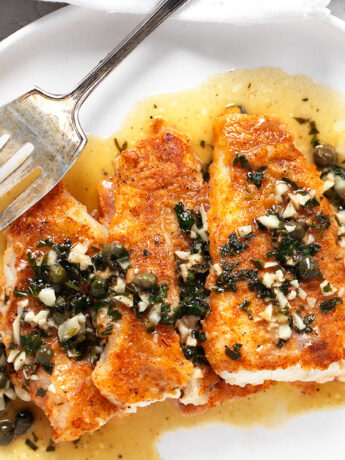 Cod piccata on plate with fork.