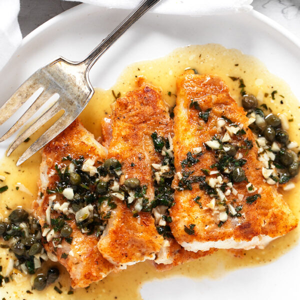 Cod piccata on plate with fork.