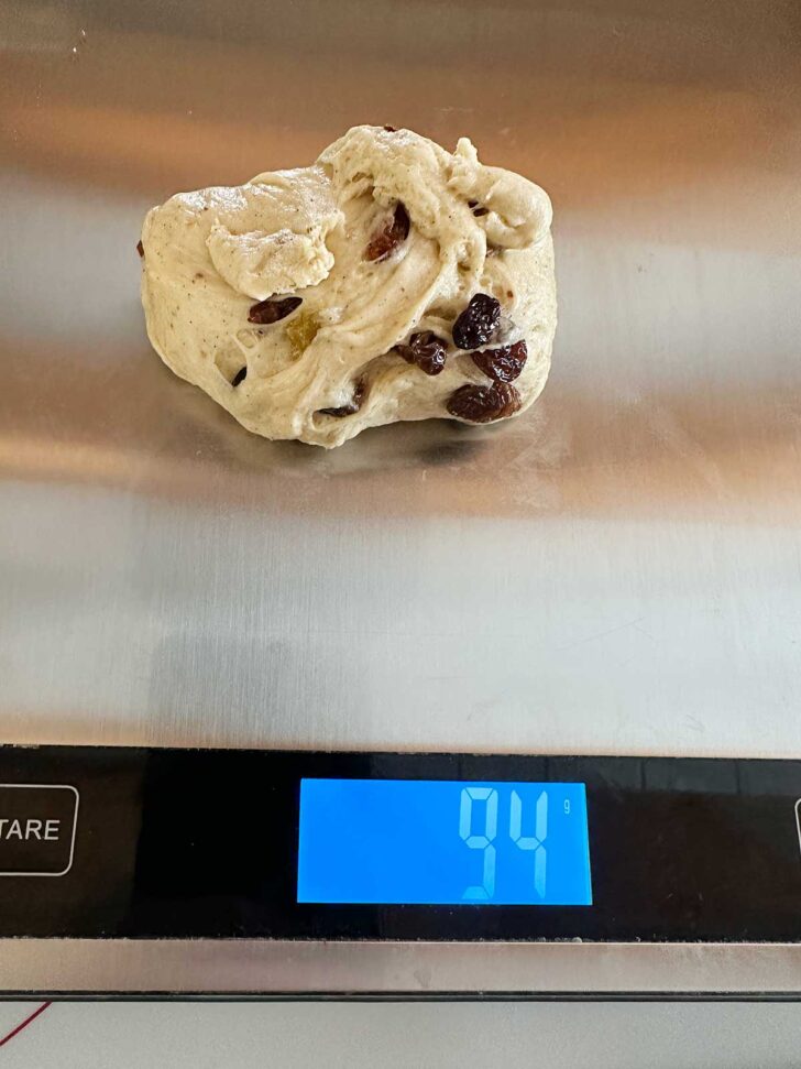 Weighing out the dough balls on a kitchen scale.