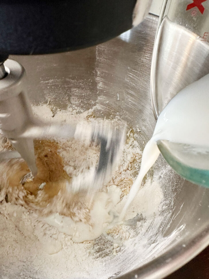 Adding the milk to the batter.