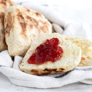 Irish soda farls on tea towel split with jam.